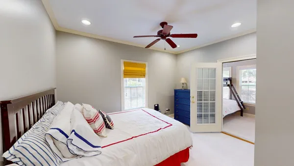a bedroom with a large bed and a chandelier