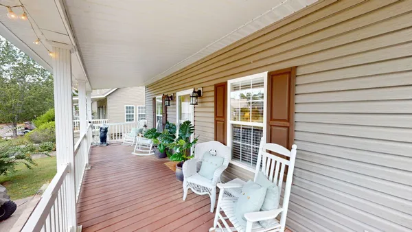 a balcony with furniture and wooden floor