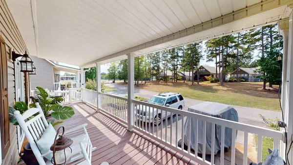 a view of a porch with wooden floor