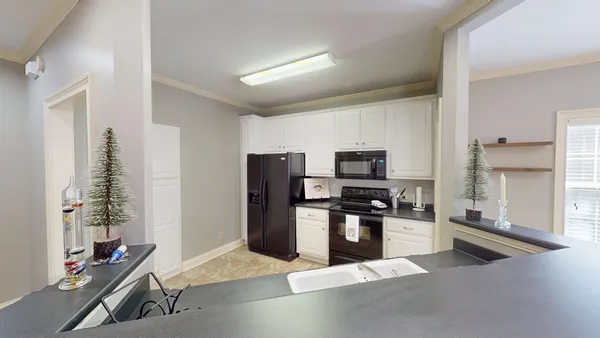a kitchen with stainless steel appliances granite countertop a refrigerator and a stove