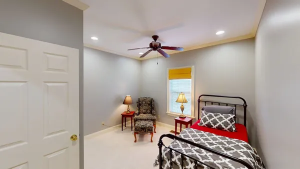 a bedroom with a bed and a chandelier