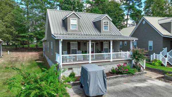 a front view of a house with a garden