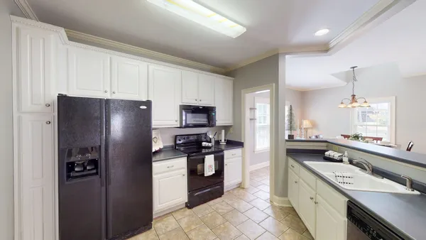a bathroom with a granite countertop sink a large mirror and a shower