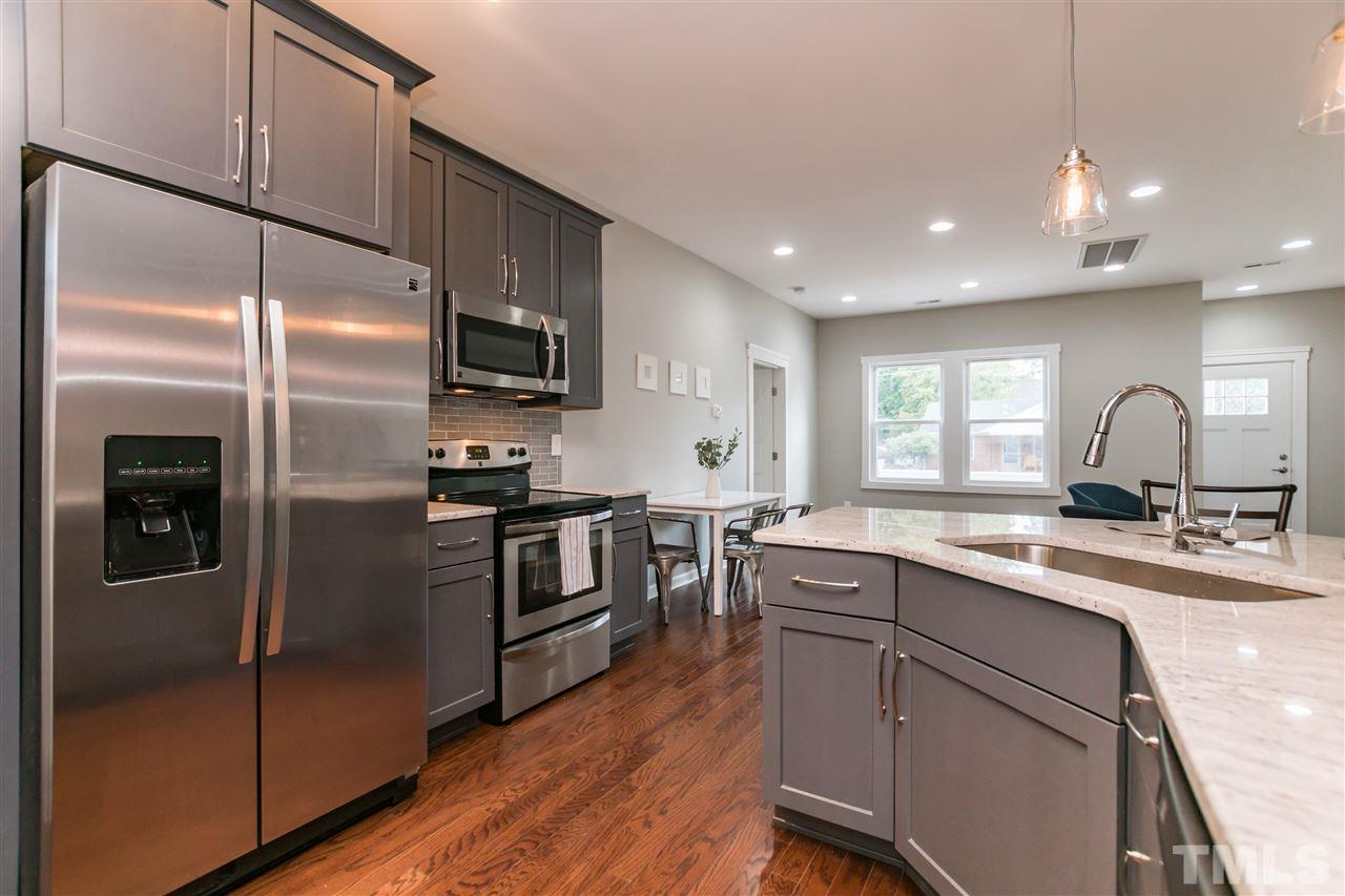 830 East Martin Street Raleigh, NC 27601 - Photo 11 of 24 a kitchen with a refrigerator sink and cabinets