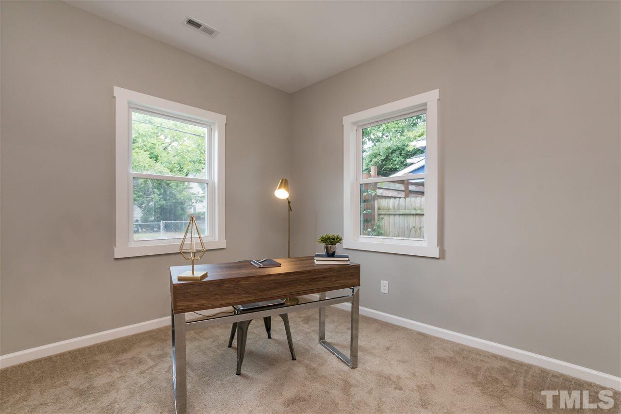 830 East Martin Street Raleigh, NC 27601 - Photo 20 of 24 a workspace with wooden floor and a window