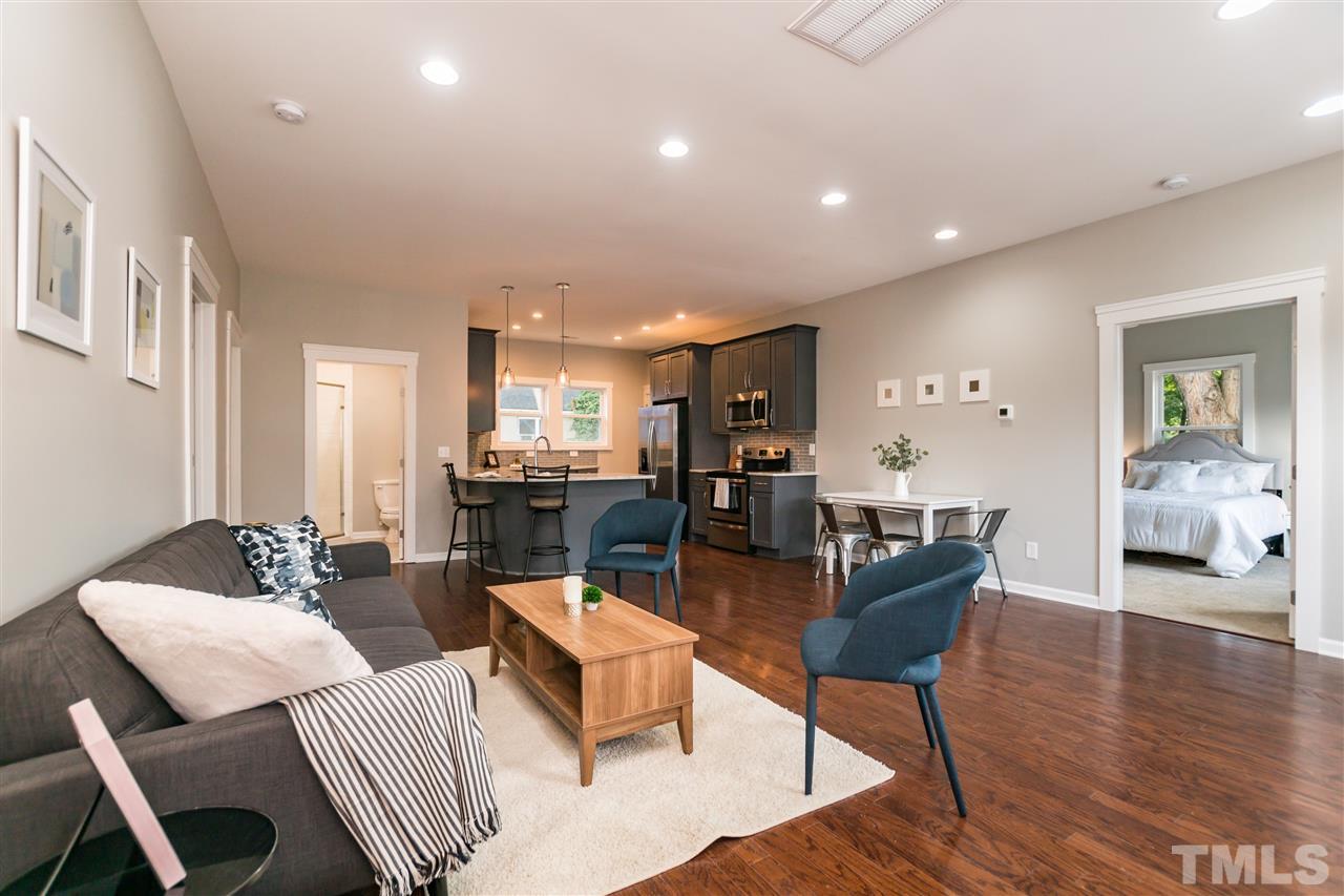 830 East Martin Street Raleigh, NC 27601 - Photo 4 of 24 a living room with furniture a table and wooden floor