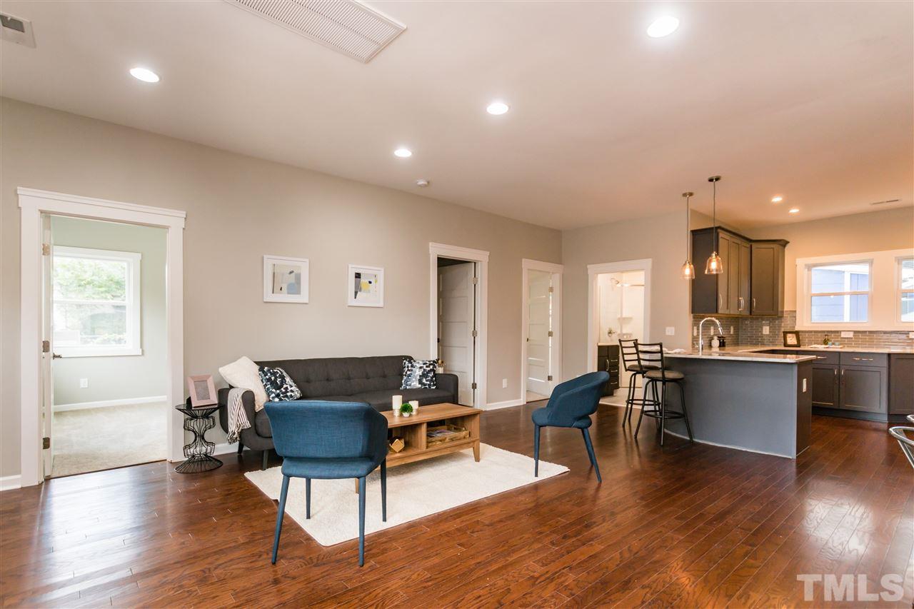 830 East Martin Street Raleigh, NC 27601 - Photo 5 of 24 a living room with furniture a dining table wooden floor and a window