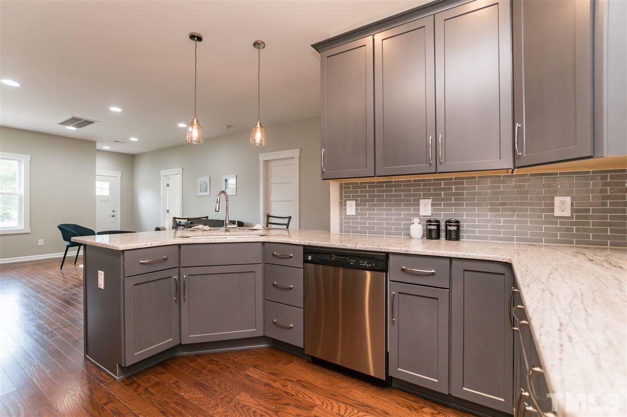 830 East Martin Street Raleigh, NC 27601 - Photo 10 of 24 a kitchen with a sink cabinets and wooden floor