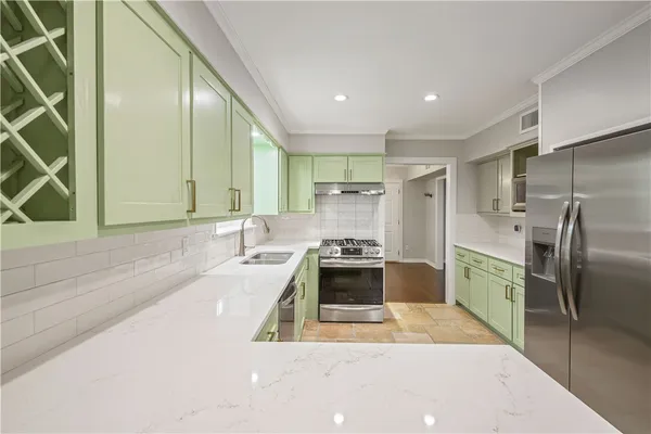 a kitchen with a sink stove and cabinets