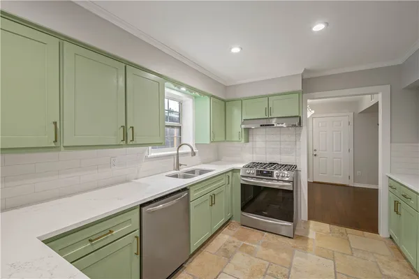 a kitchen with a sink a counter and cabinets