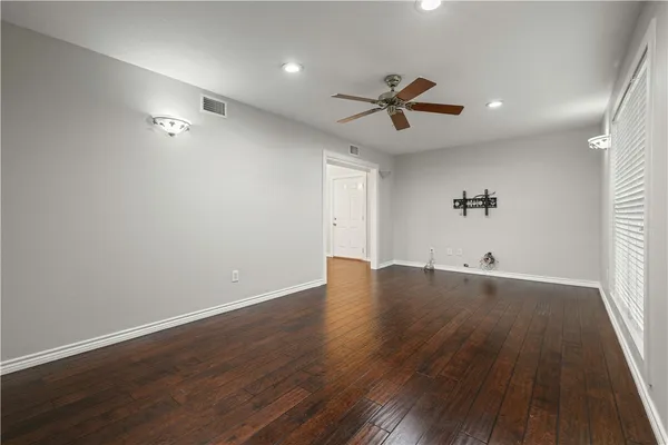 a view of a room with wooden floor and windows