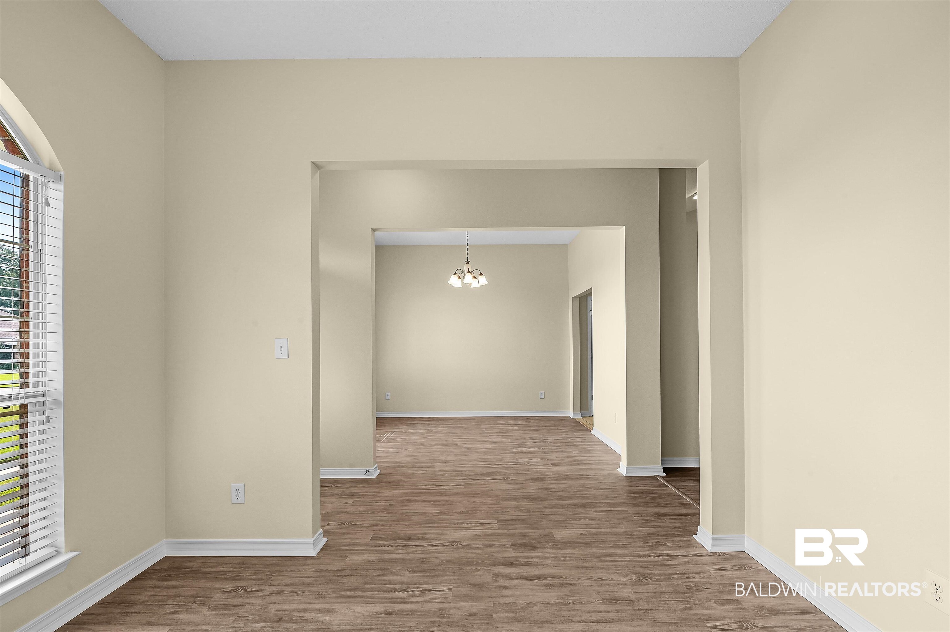 12443 Venice Boulevard Foley, AL 36535 - Photo 17 of 59 Hall with hardwood / wood-style flooring and an inviting chandelier