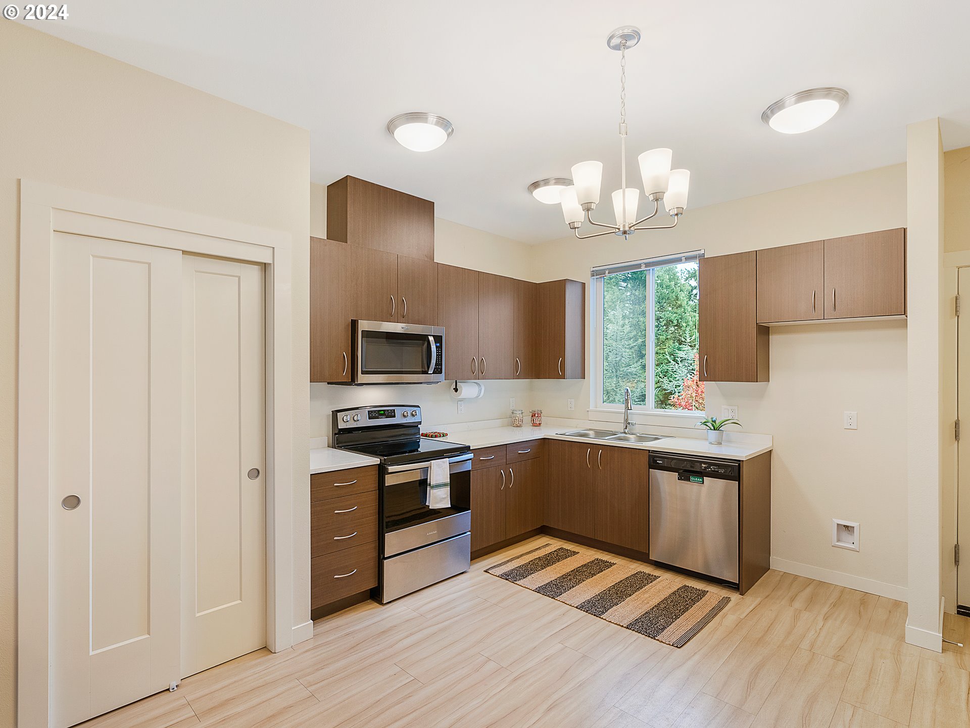 10827 East Burnside Street Portland, OR 97216 - Photo 11 of 28 a kitchen with cabinets a sink and appliances