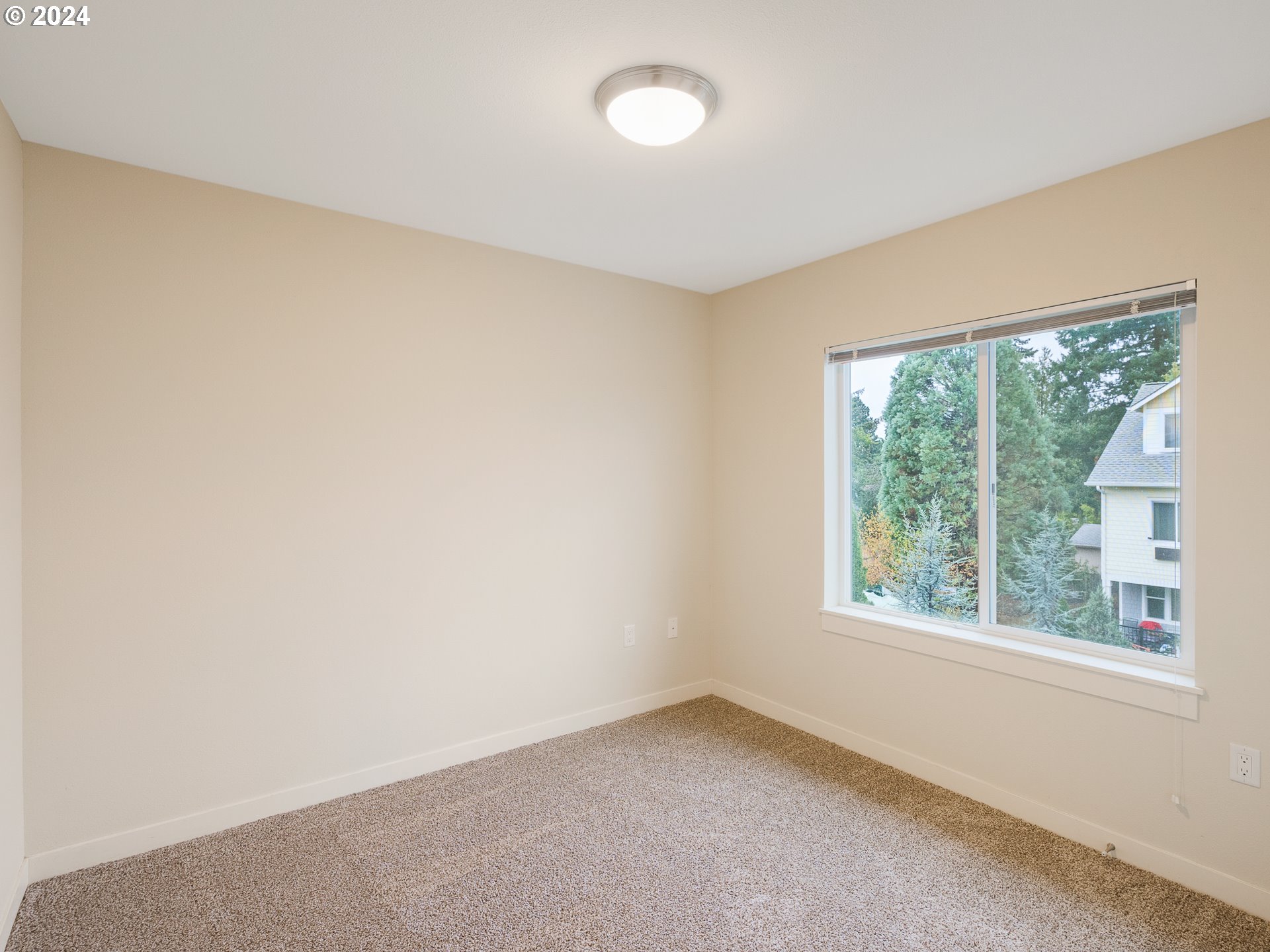 10827 East Burnside Street Portland, OR 97216 - Photo 19 of 28 an empty room with a window
