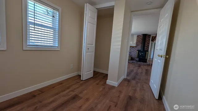a view of hallway with a closet and a window