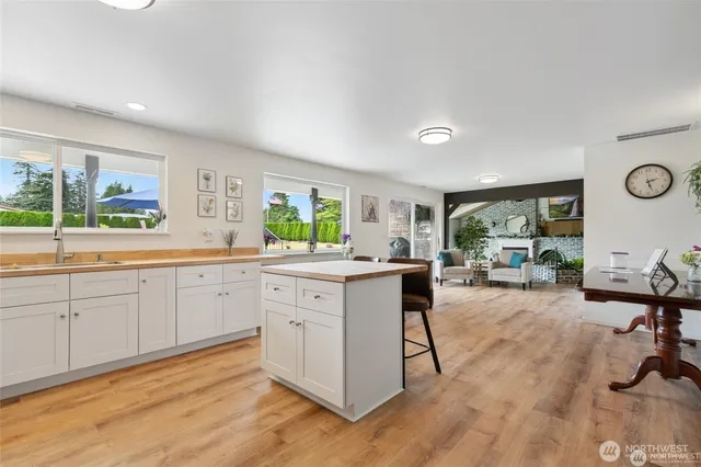 a kitchen with sink cabinets and dining area view