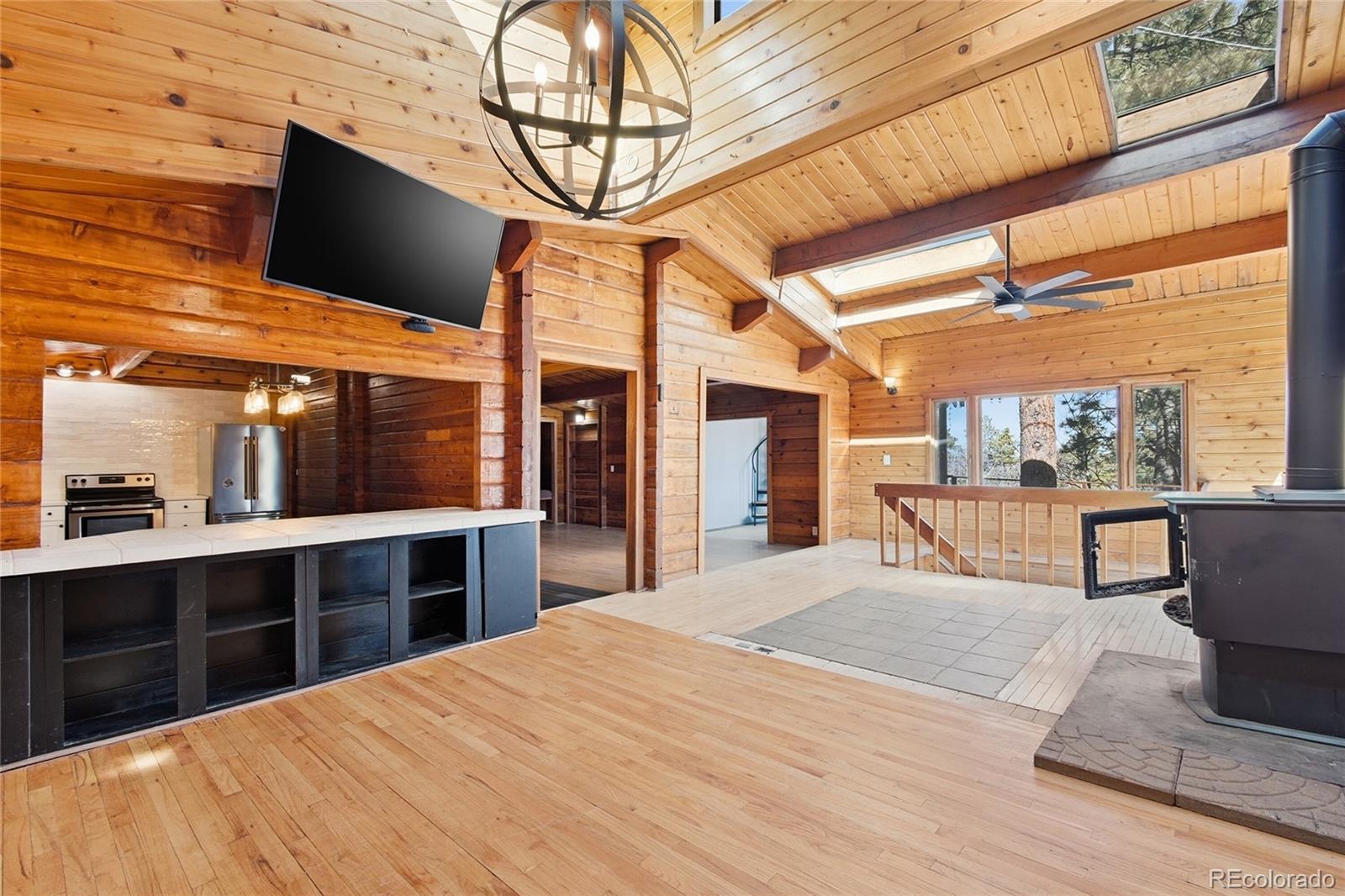 61 Ramona Road Golden, CO 80403 - Photo 15 of 49 a large kitchen with stainless steel appliances kitchen island granite countertop a table chairs in it and wooden floor