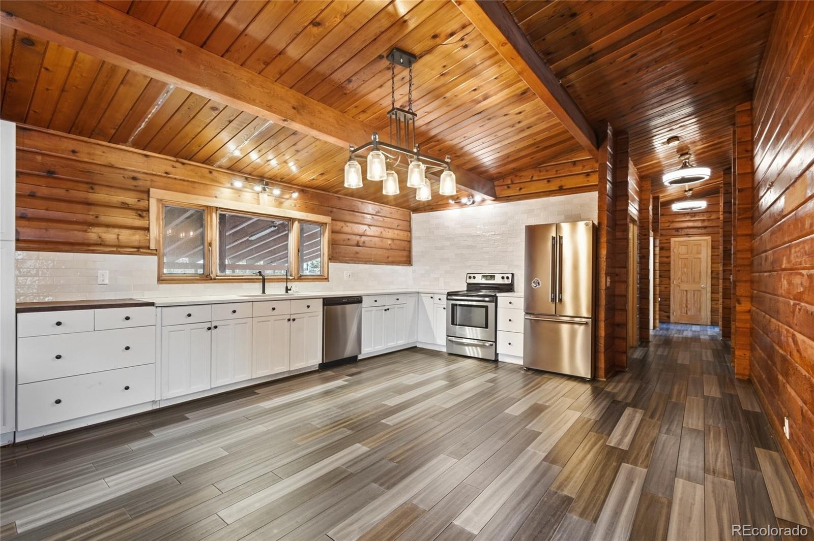 61 Ramona Road Golden, CO 80403 - Photo 17 of 49 a kitchen with white cabinets and white appliances