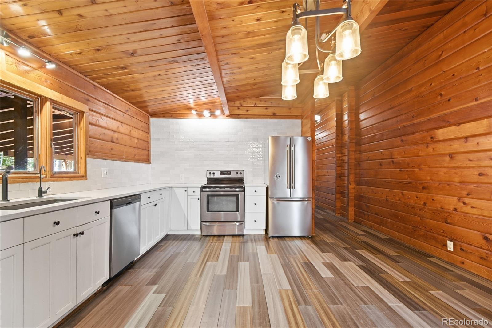 61 Ramona Road Golden, CO 80403 - Photo 19 of 49 a kitchen with a sink and wooden floor