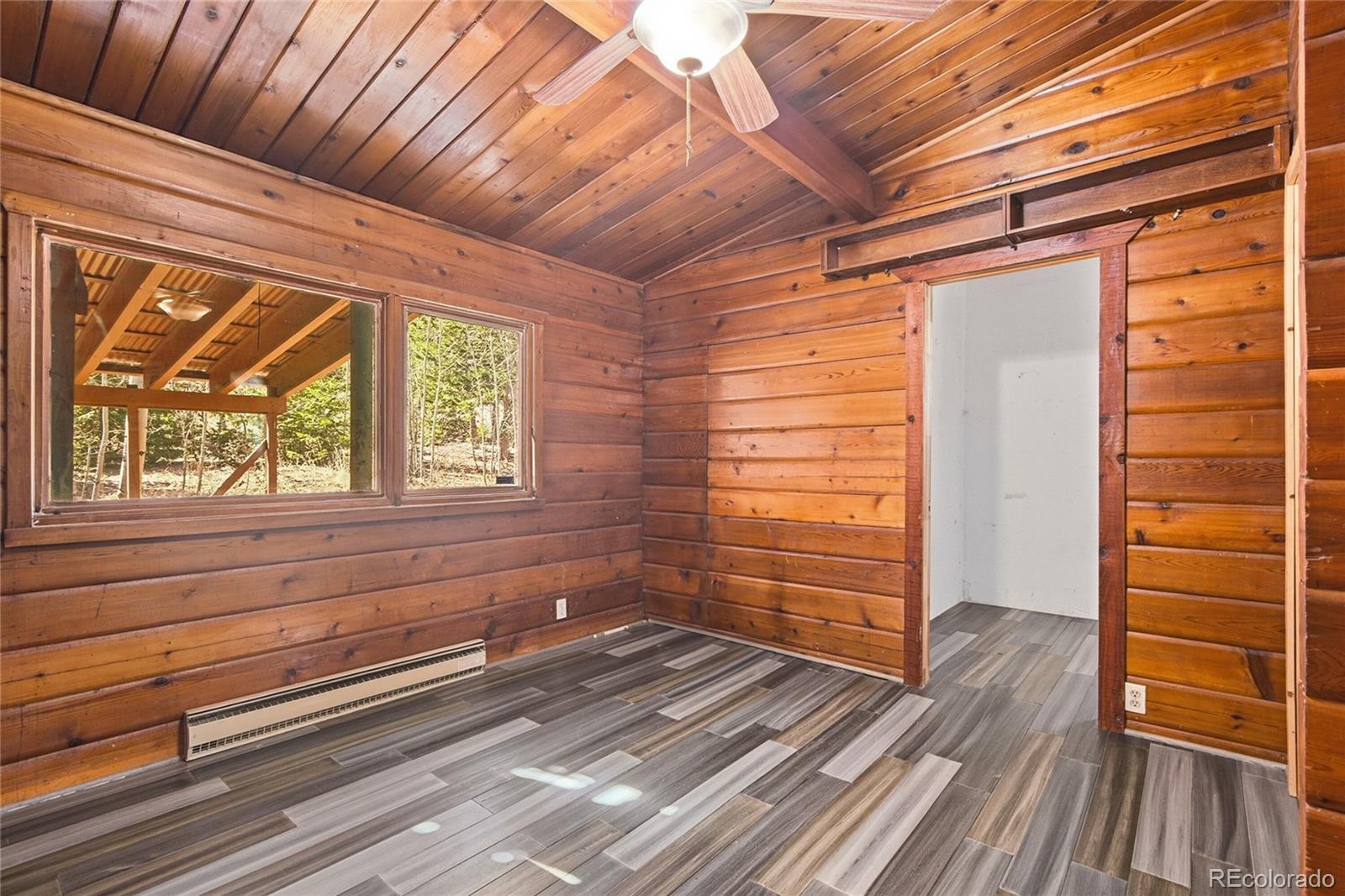 61 Ramona Road Golden, CO 80403 - Photo 23 of 49 a view of empty room with wooden floor and fan