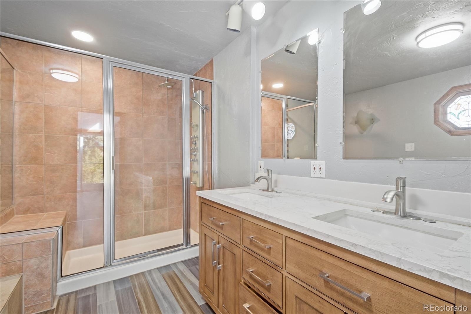61 Ramona Road Golden, CO 80403 - Photo 29 of 49 a bathroom with a shower sink vanity and mirror