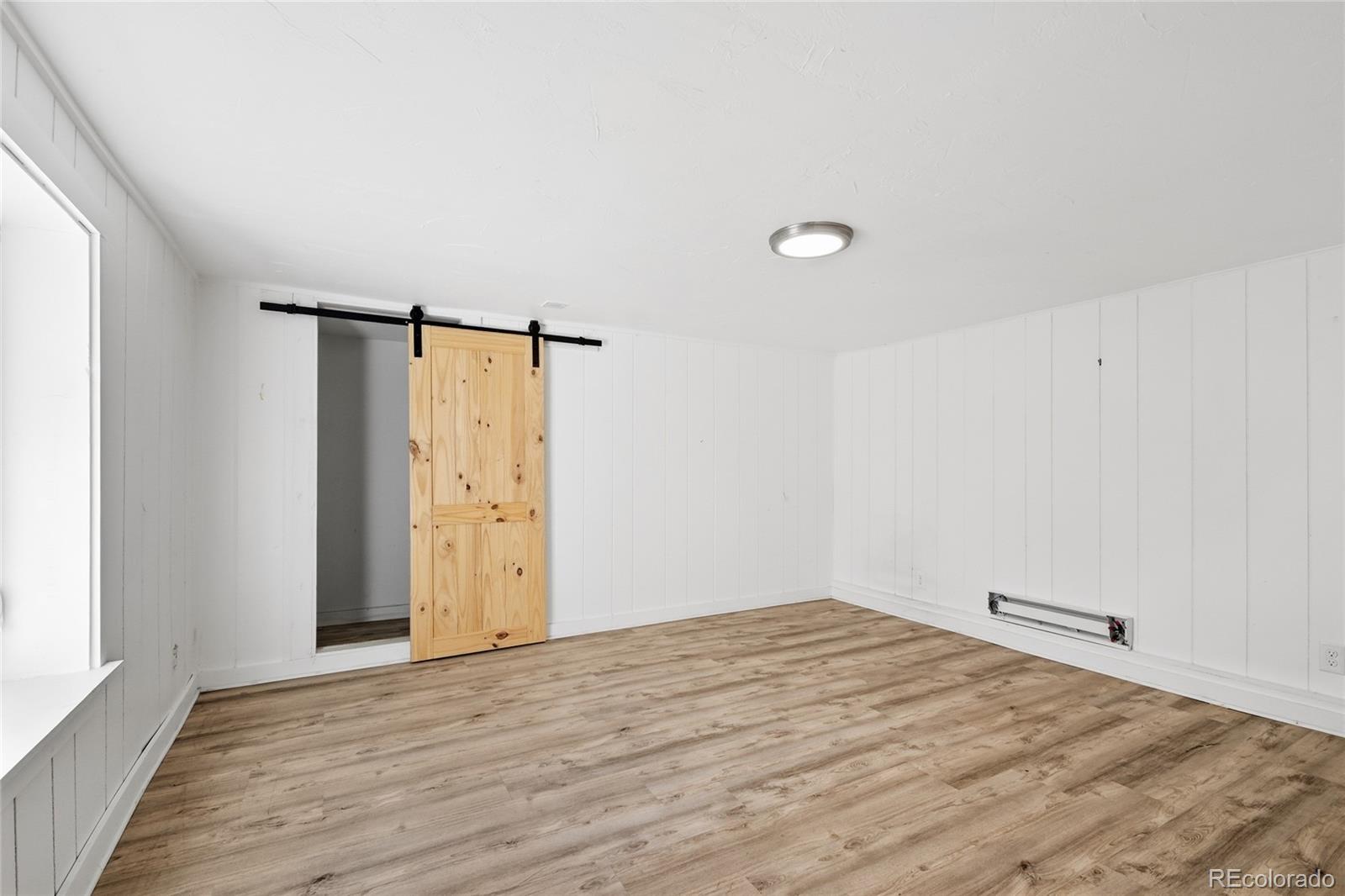 61 Ramona Road Golden, CO 80403 - Photo 31 of 49 a view of empty room with wooden floor and fan