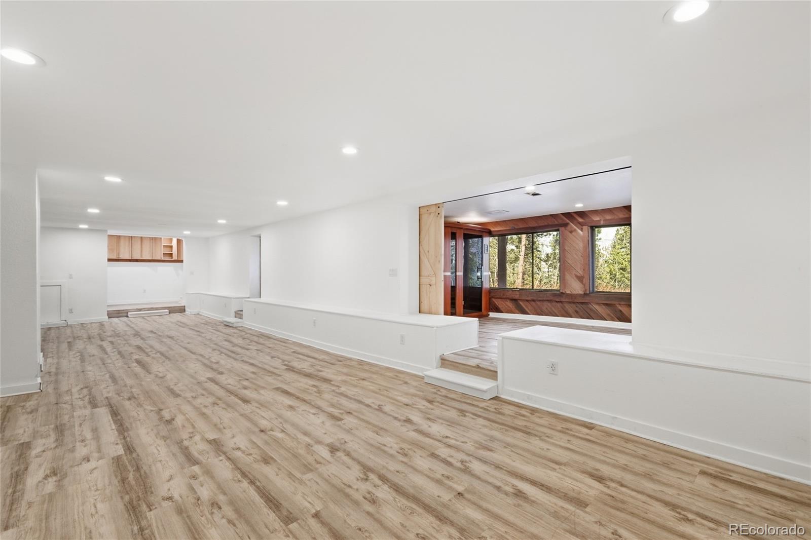 61 Ramona Road Golden, CO 80403 - Photo 34 of 49 a view of an empty room with wooden floor and a window