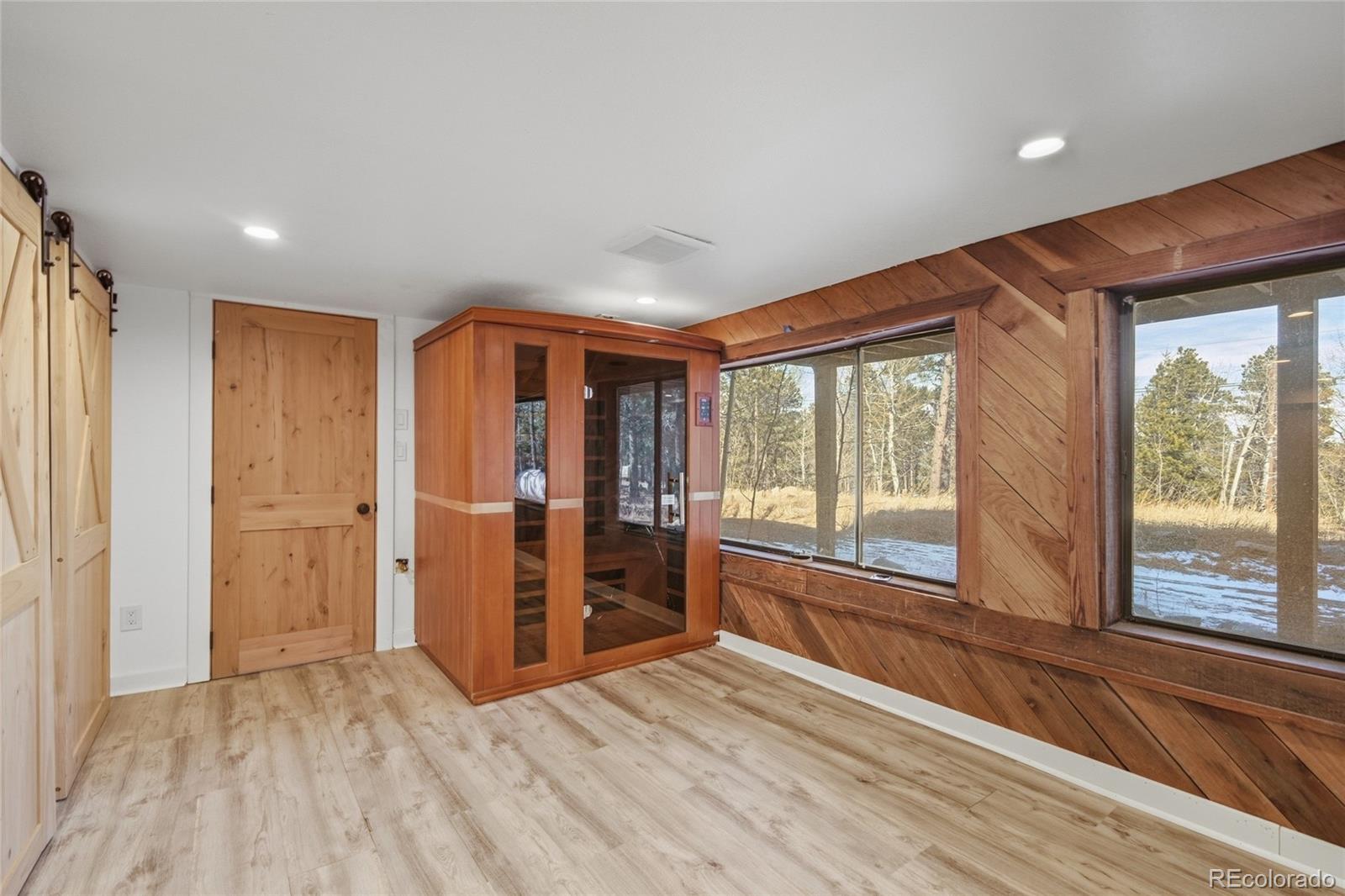 61 Ramona Road Golden, CO 80403 - Photo 35 of 49 a view of empty room with wooden floor and fan