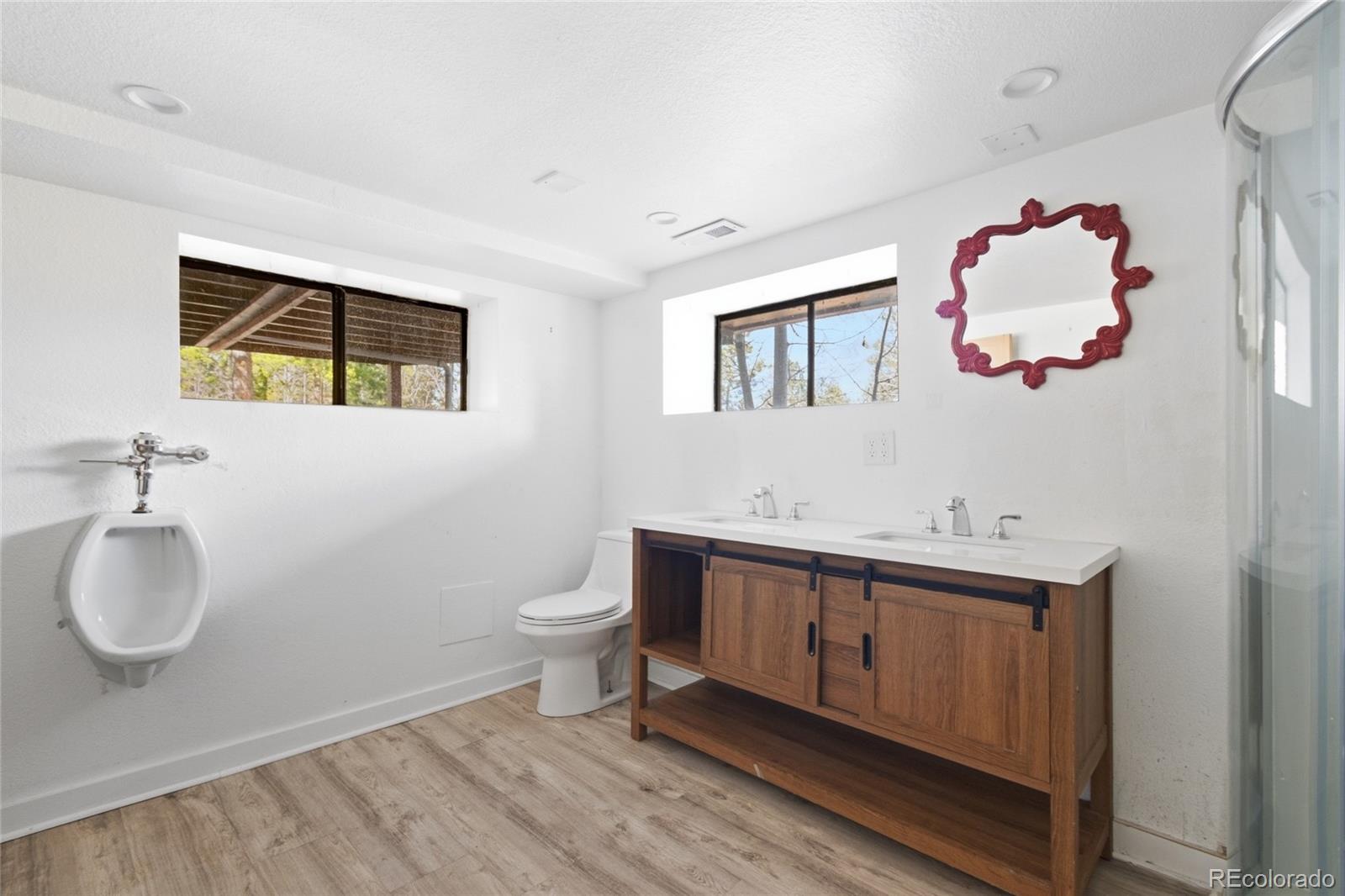 61 Ramona Road Golden, CO 80403 - Photo 39 of 49 a bathroom with a toilet sink vanity and mirror