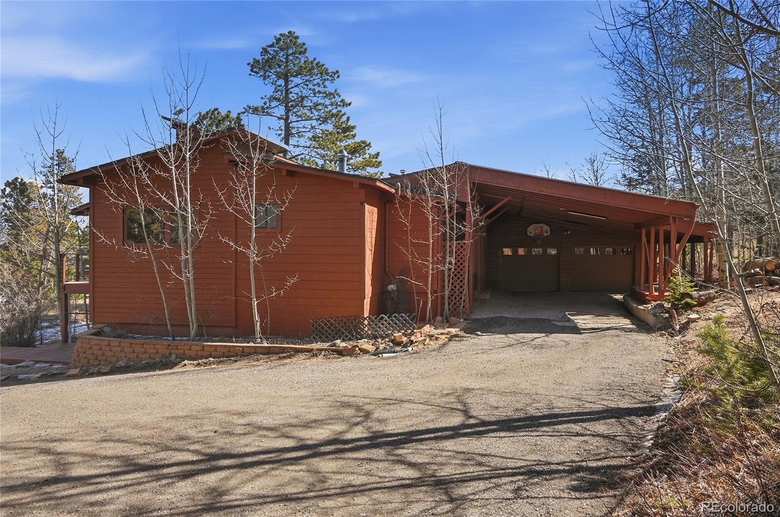 61 Ramona Road Golden, CO 80403 - Photo 42 of 49 a view of house with backyard and trees