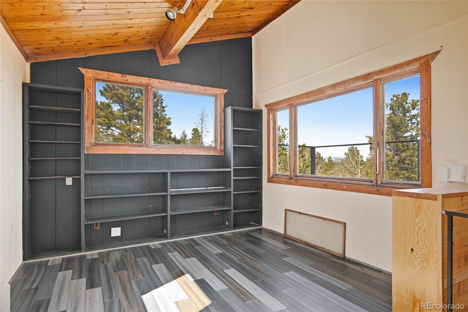 61 Ramona Road Golden, CO 80403 - Photo 6 of 49 a room with wooden floor and windows