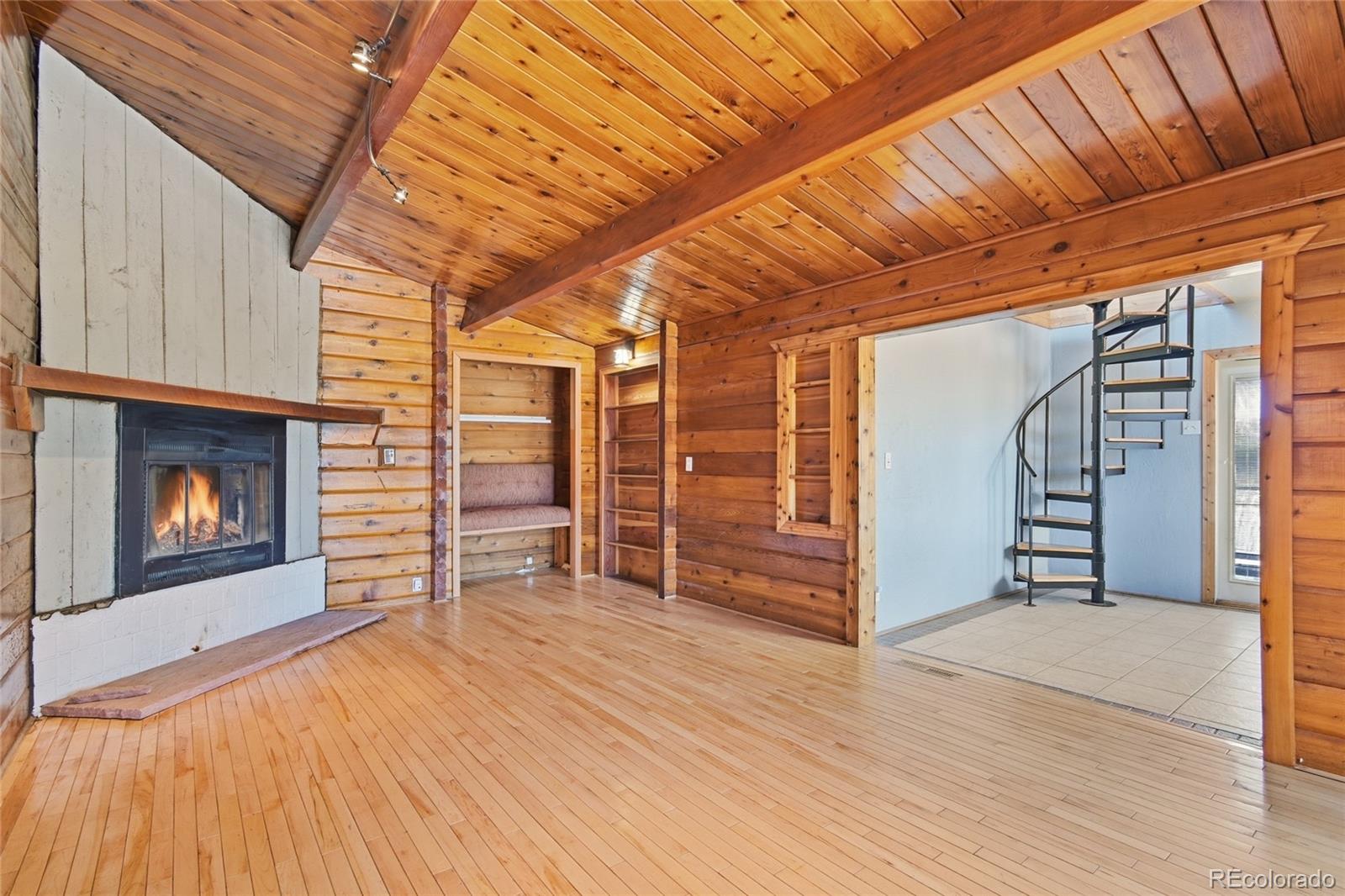 61 Ramona Road Golden, CO 80403 - Photo 8 of 49 a view of empty room with wooden floor and fireplace