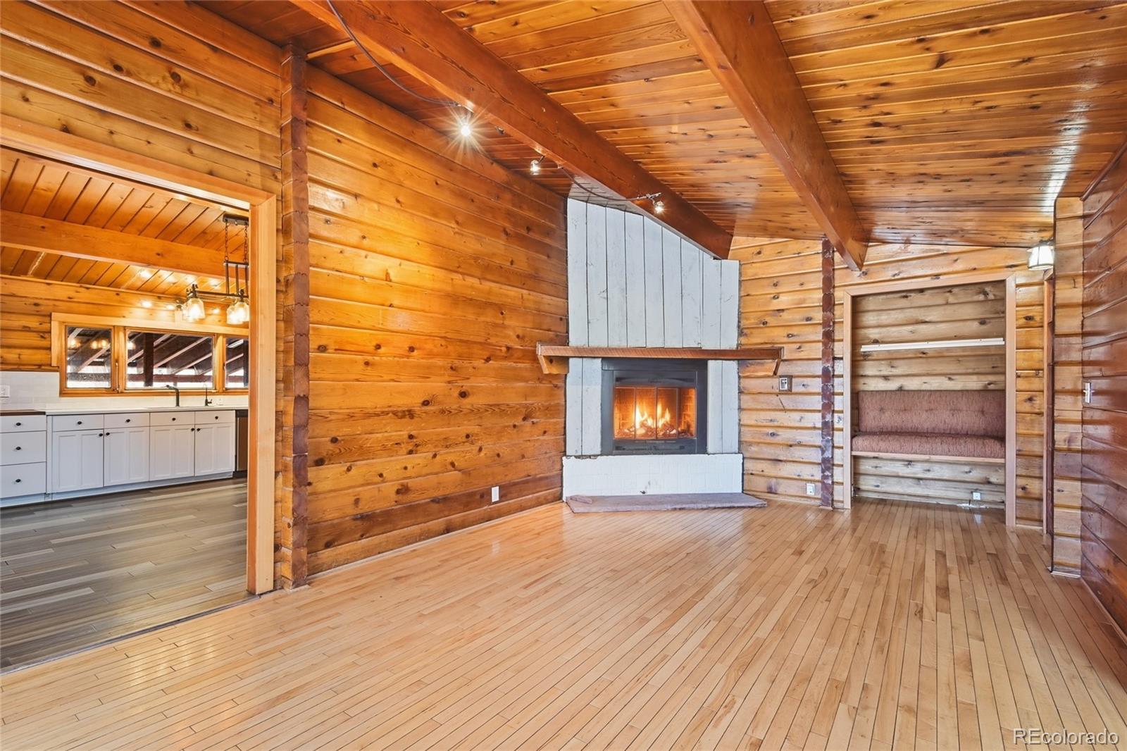 61 Ramona Road Golden, CO 80403 - Photo 9 of 49 a view of empty room with wooden floor and fireplace