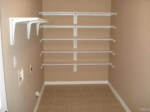 8829 Breeland Way Raleigh, NC 27613 - Photo 9 of 12 Huge Laundry Room with ceramic tile and tons of shelving! On the second floor close to all the bedrooms!