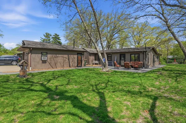 a view of a house with a yard patio and swimming pool