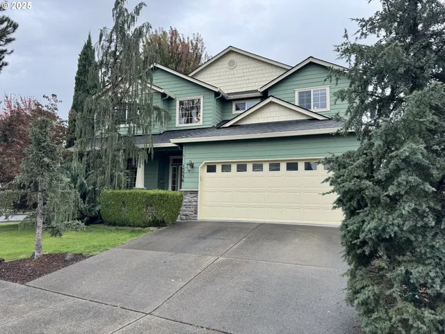 a front view of a house with a garden and plants