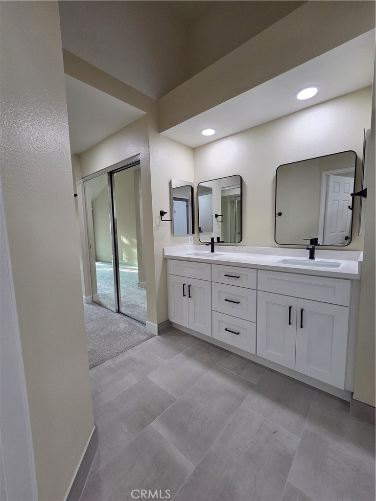 35 Ericson Aisle Irvine, CA 92620 - Photo 12 of 21 a spacious bathroom with double vanity a and mirror