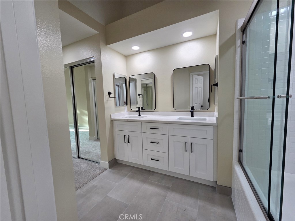 35 Ericson Aisle Irvine, CA 92620 - Photo 13 of 21 a bathroom with a double vanity sink and a mirror