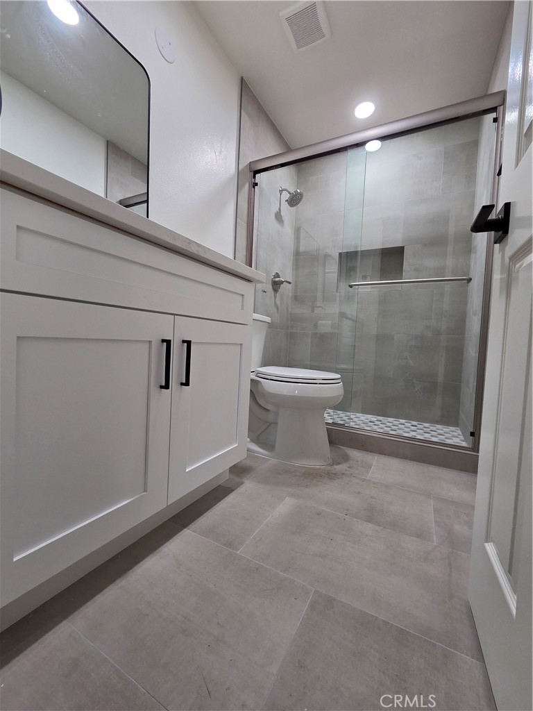 35 Ericson Aisle Irvine, CA 92620 - Photo 16 of 21 a bathroom with a white toilet and a shower