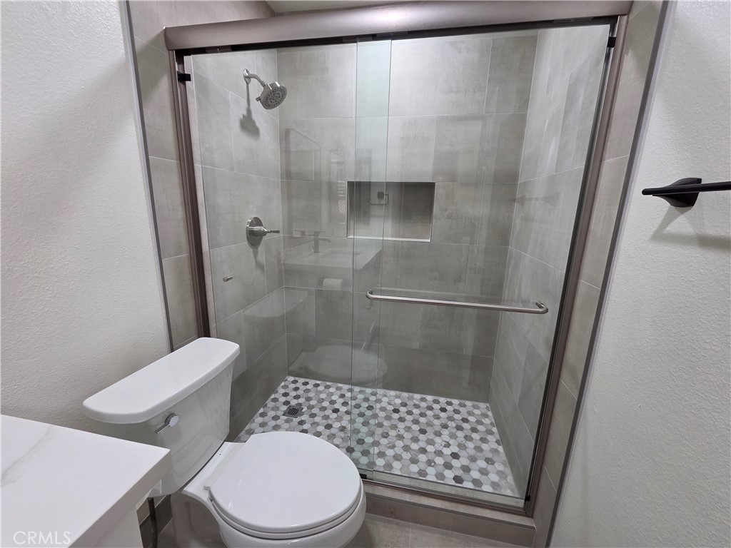 35 Ericson Aisle Irvine, CA 92620 - Photo 17 of 21 a bathroom with a toilet and a shower