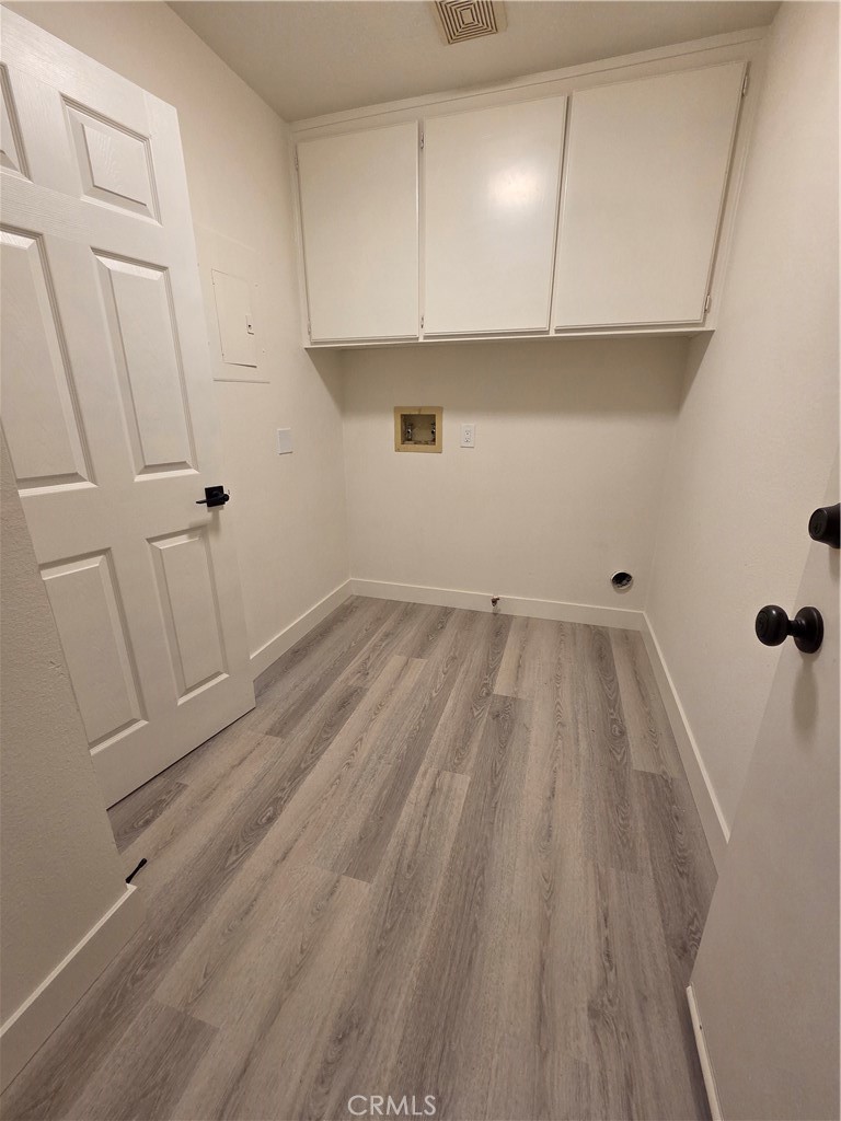 35 Ericson Aisle Irvine, CA 92620 - Photo 18 of 21 a view of a closet with wooden floor