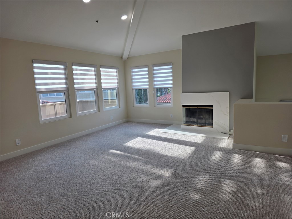 35 Ericson Aisle Irvine, CA 92620 - Photo 2 of 21 an empty room with fireplace and windows