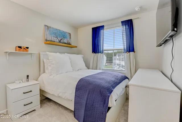 a bedroom with a bed and a television