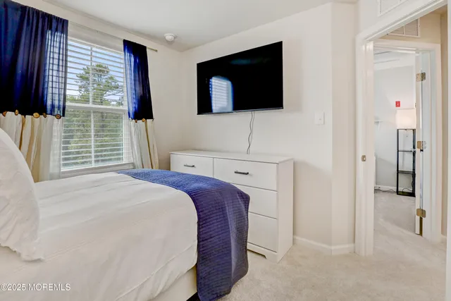 a bedroom with furniture and a window