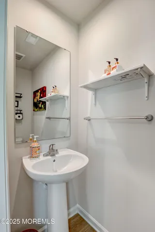 a bathroom with a sink a toilet and a mirror