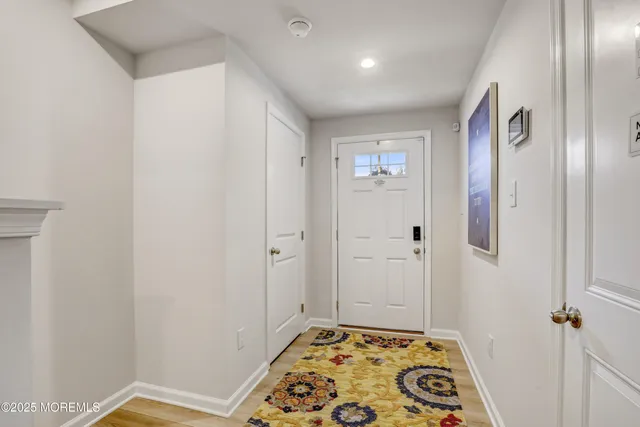 a kitchen with stainless steel appliances kitchen island a stove a sink a refrigerator white cabinets and a refrigerator