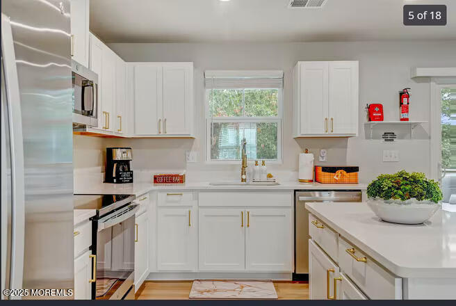 1001 Cypress Street Forked River, NJ 08731 - Photo 9 of 26 a kitchen with a sink cabinets and window