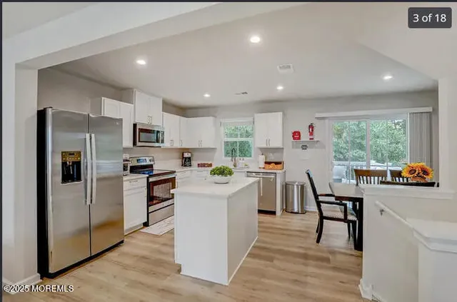 a living room with furniture and kitchen view