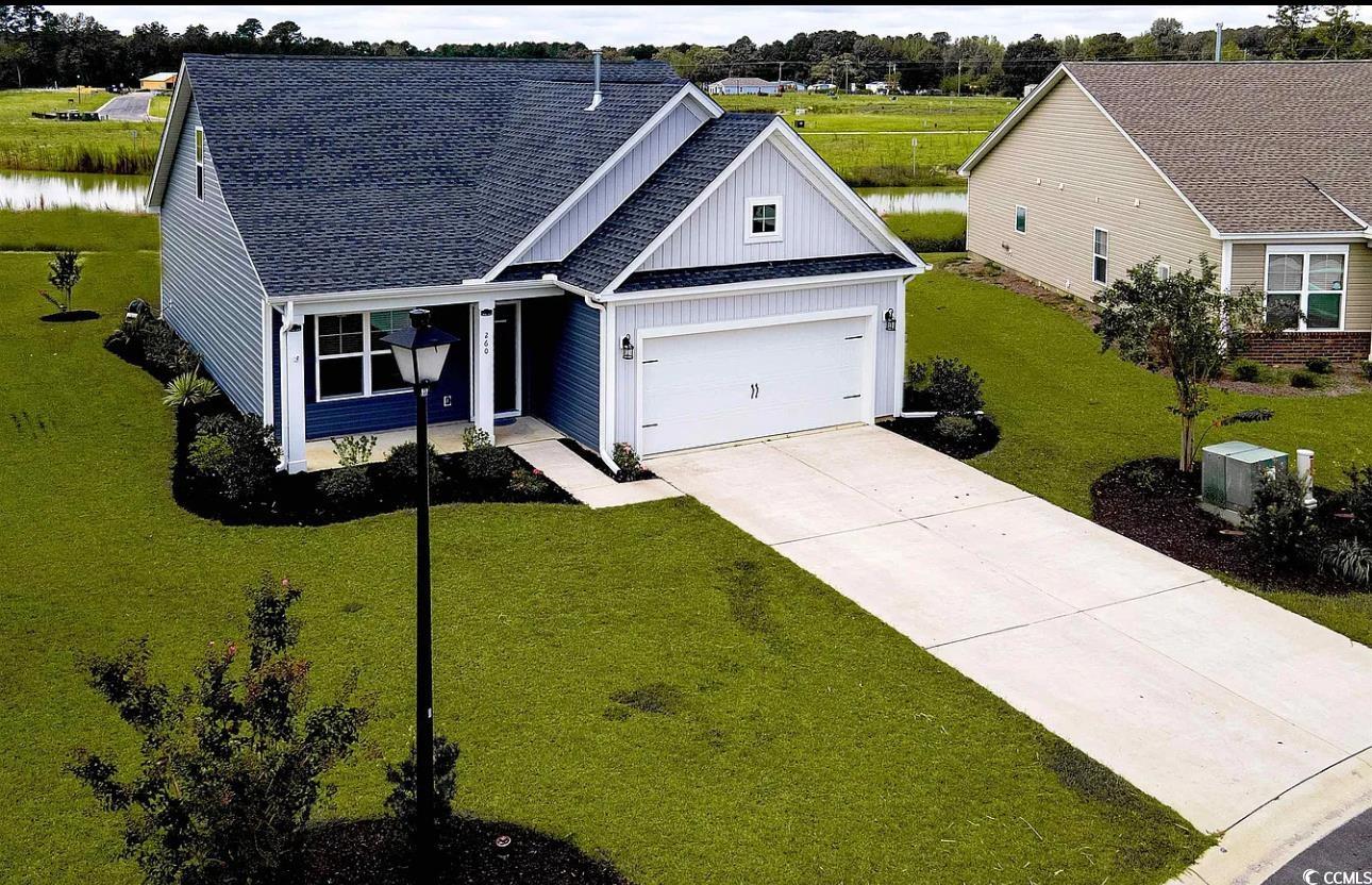 260 Red Maple Loop Longs, SC 29568 - Photo 1 of 34 View of front of house with a garage, a water view