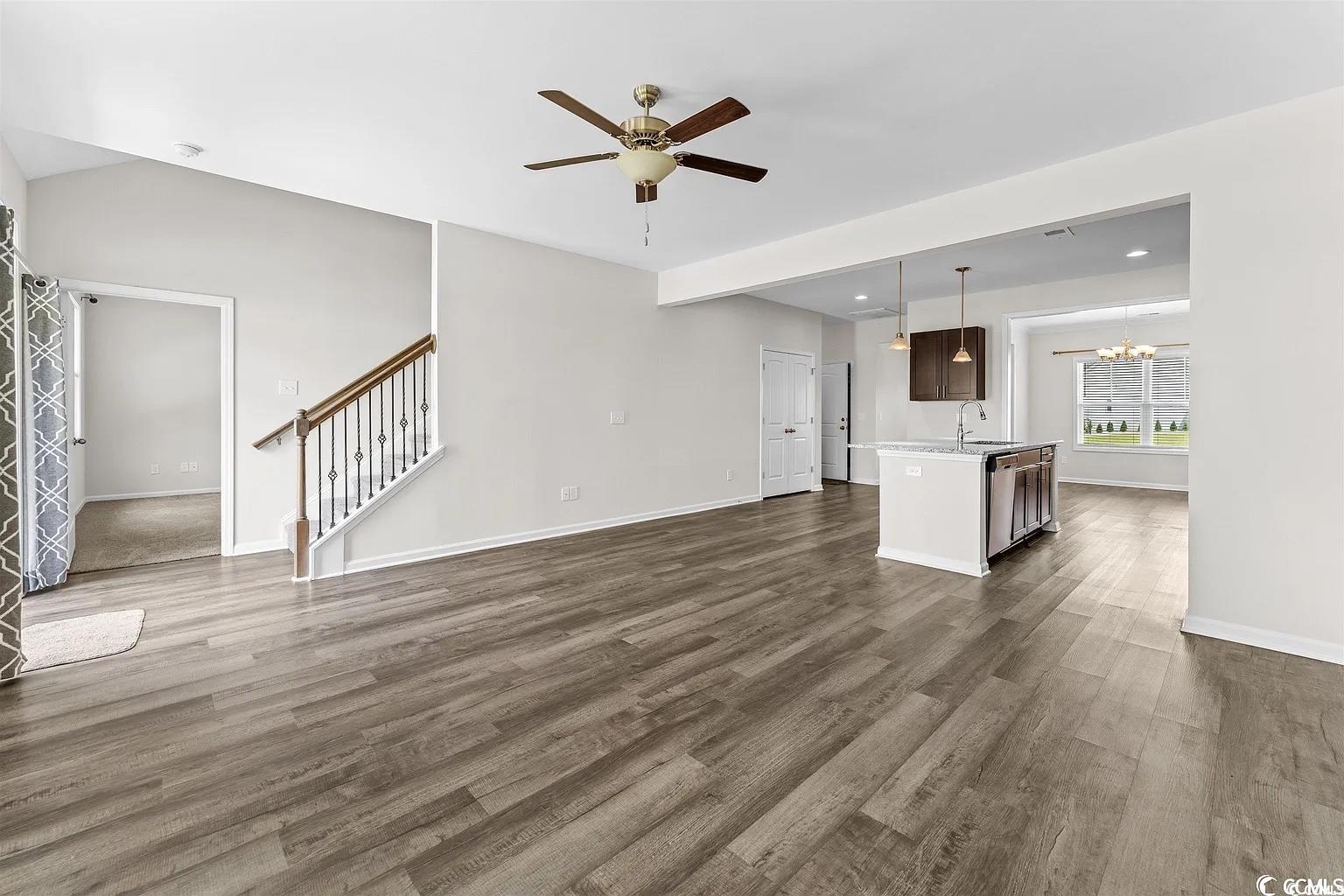 260 Red Maple Loop Longs, SC 29568 - Photo 24 of 34 Unfurnished living room with ceiling fan with nota